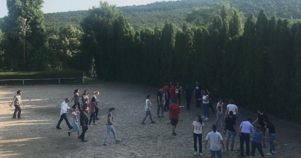 Group of people practicing outdoor activities in a field.